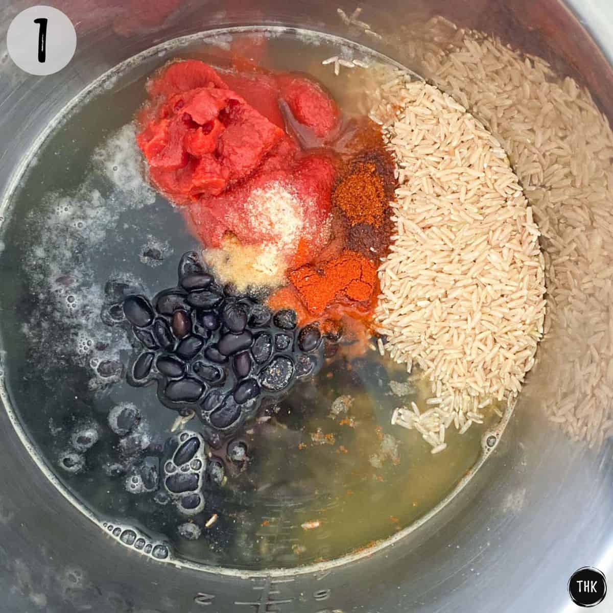 Instant Pot with brown rice, black beans, tomato paste, seasoning and broth inside.