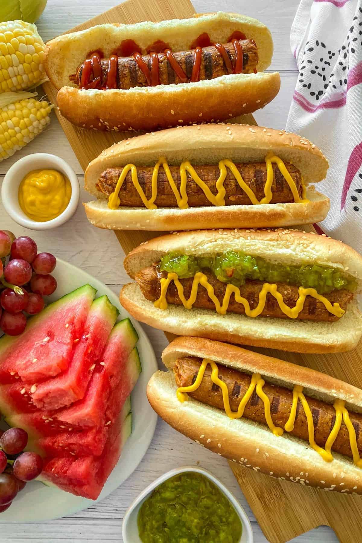 Vegan hot dogs in buns with mustard and relish on top.