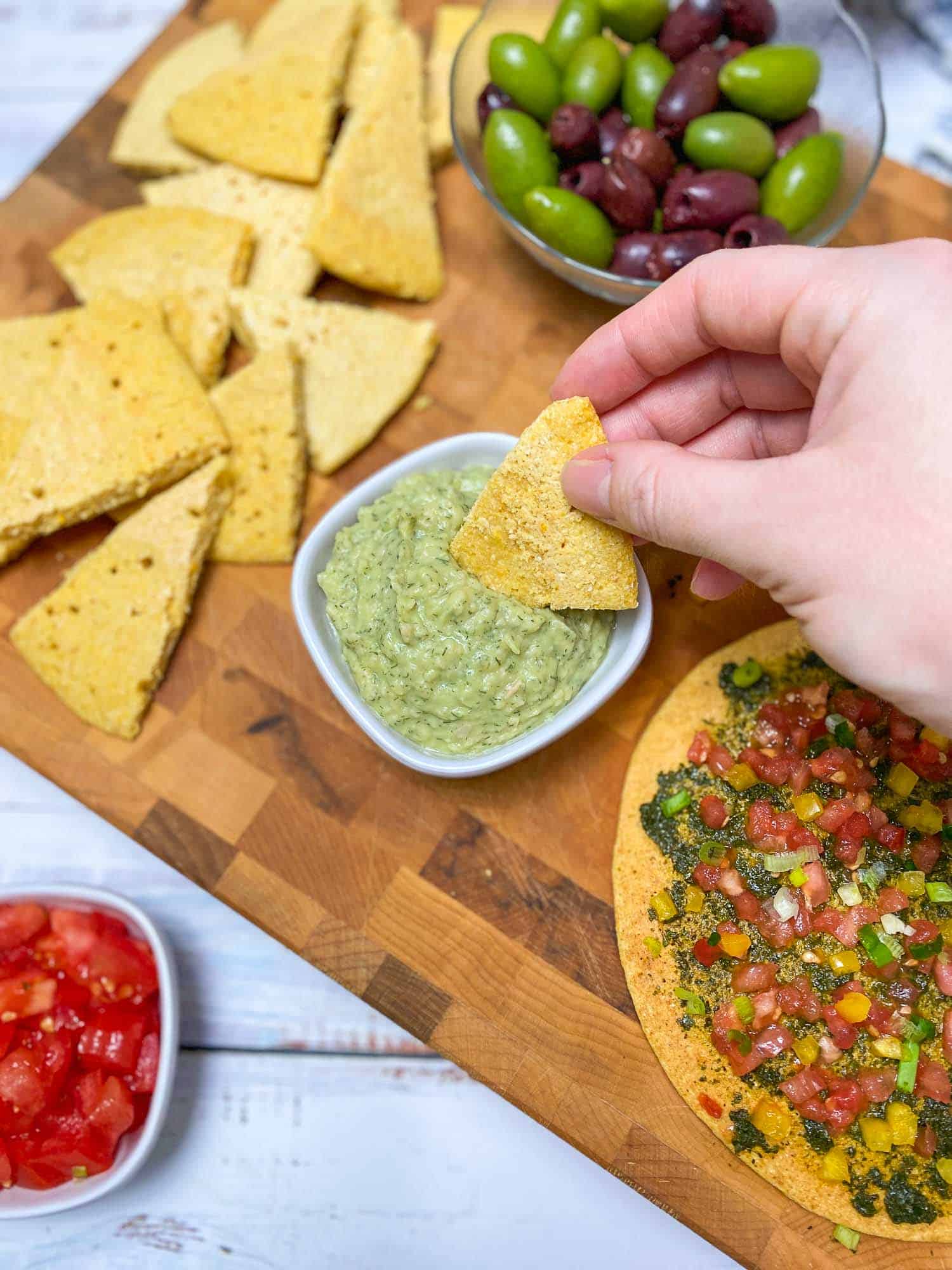dipping socca wedge into dip
