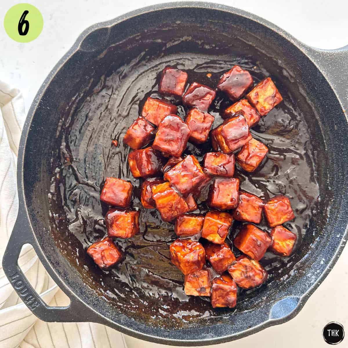 Cast iron pan with crispy tofu in a sticky spicy sauce.