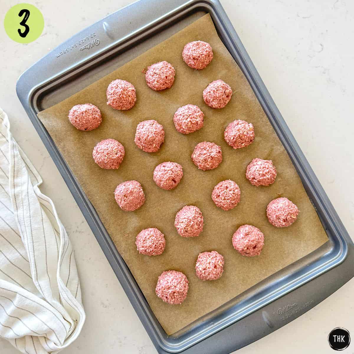 Strawberry bliss balls on baking sheet.