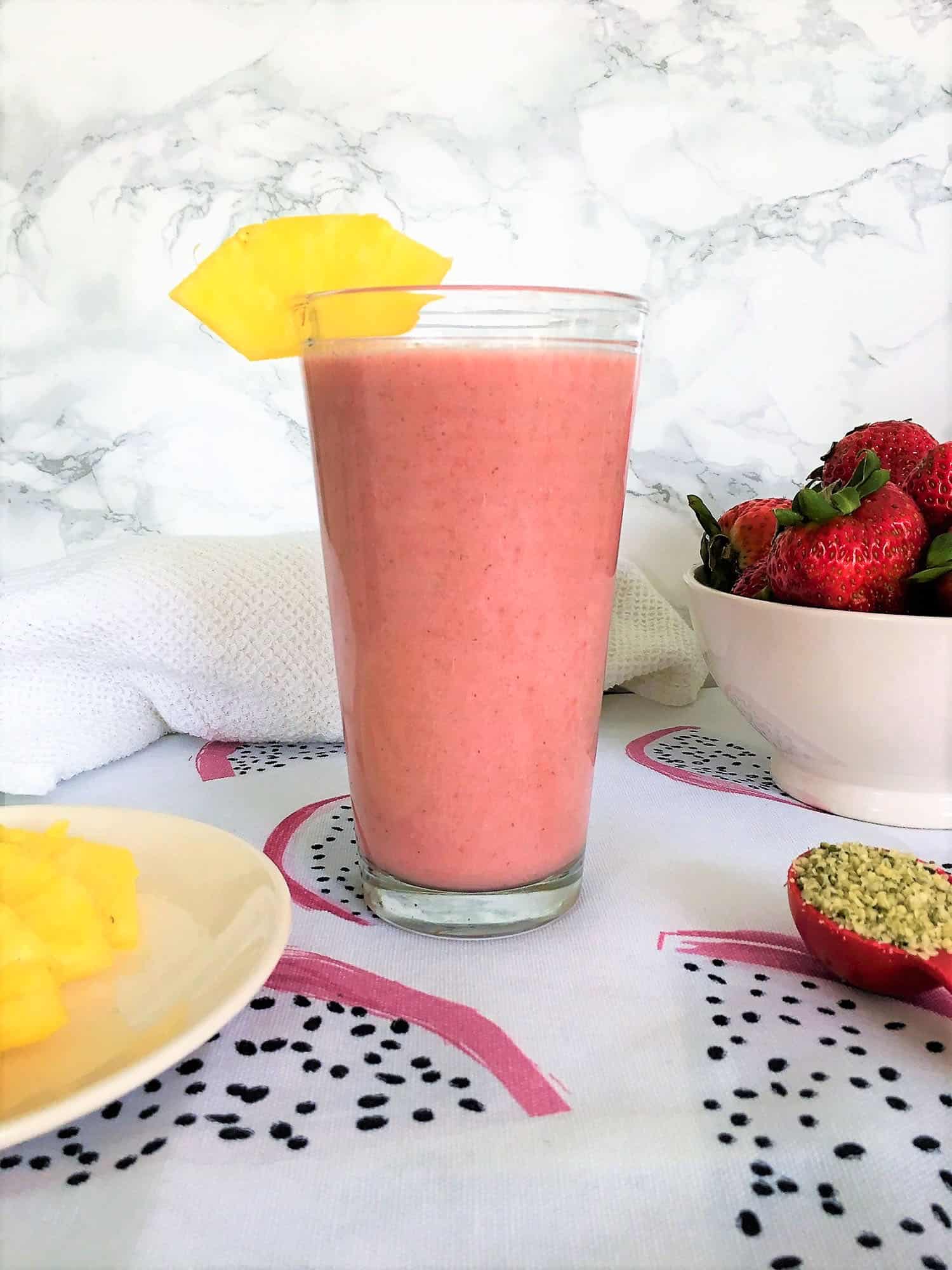 tropical smoothie with pineapple garnish