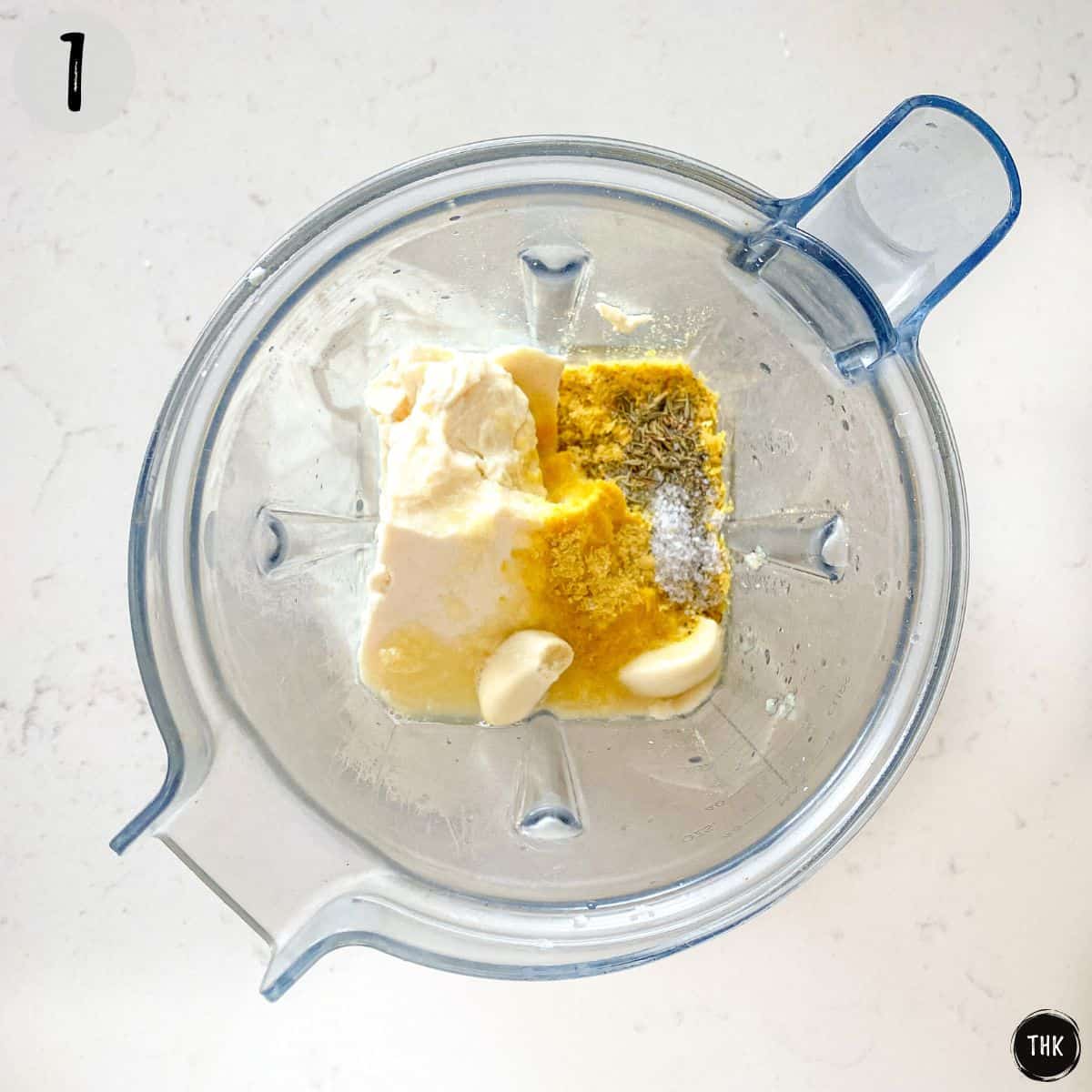 Blender with tofu, broth and spices inside.
