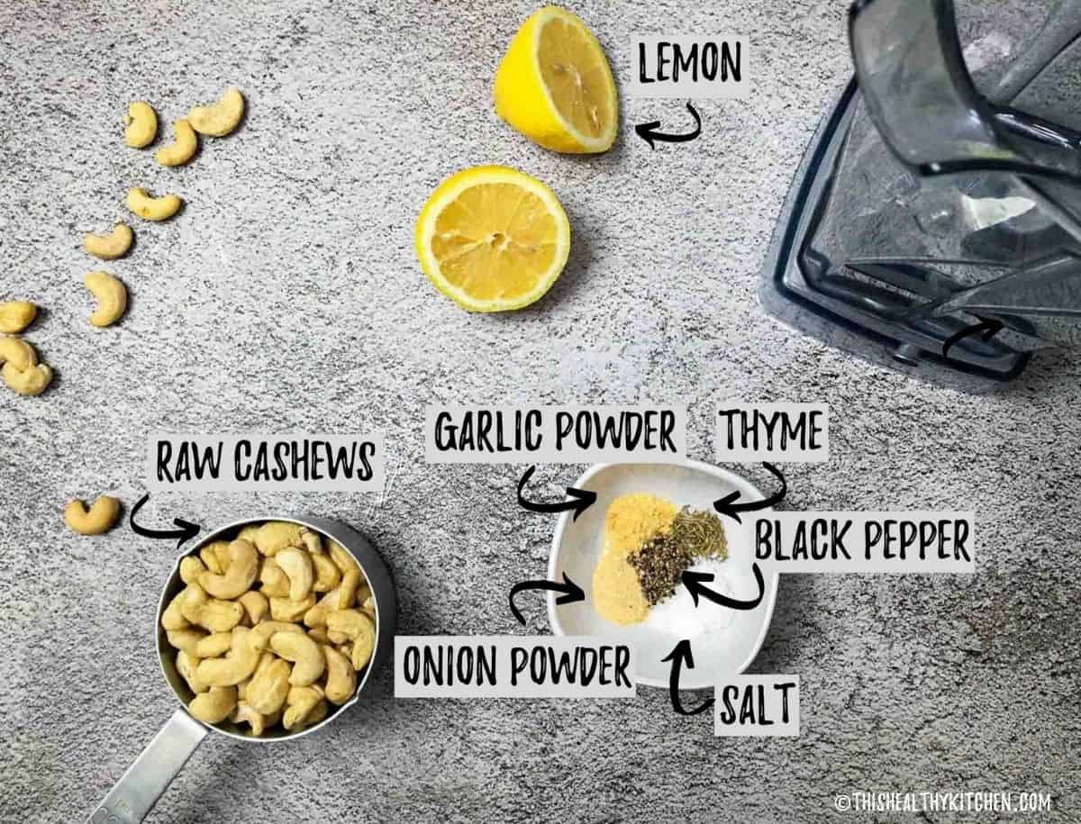 Cashews, lemon and spices on countertop.