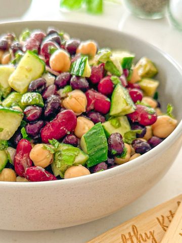Vegan bean salad in white serving bowl.