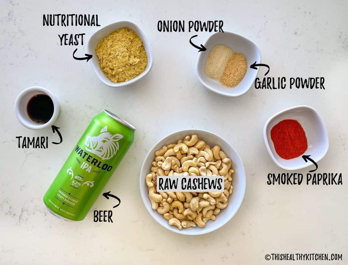 Cashews, seasoning, and beer can on kitchen counter top.