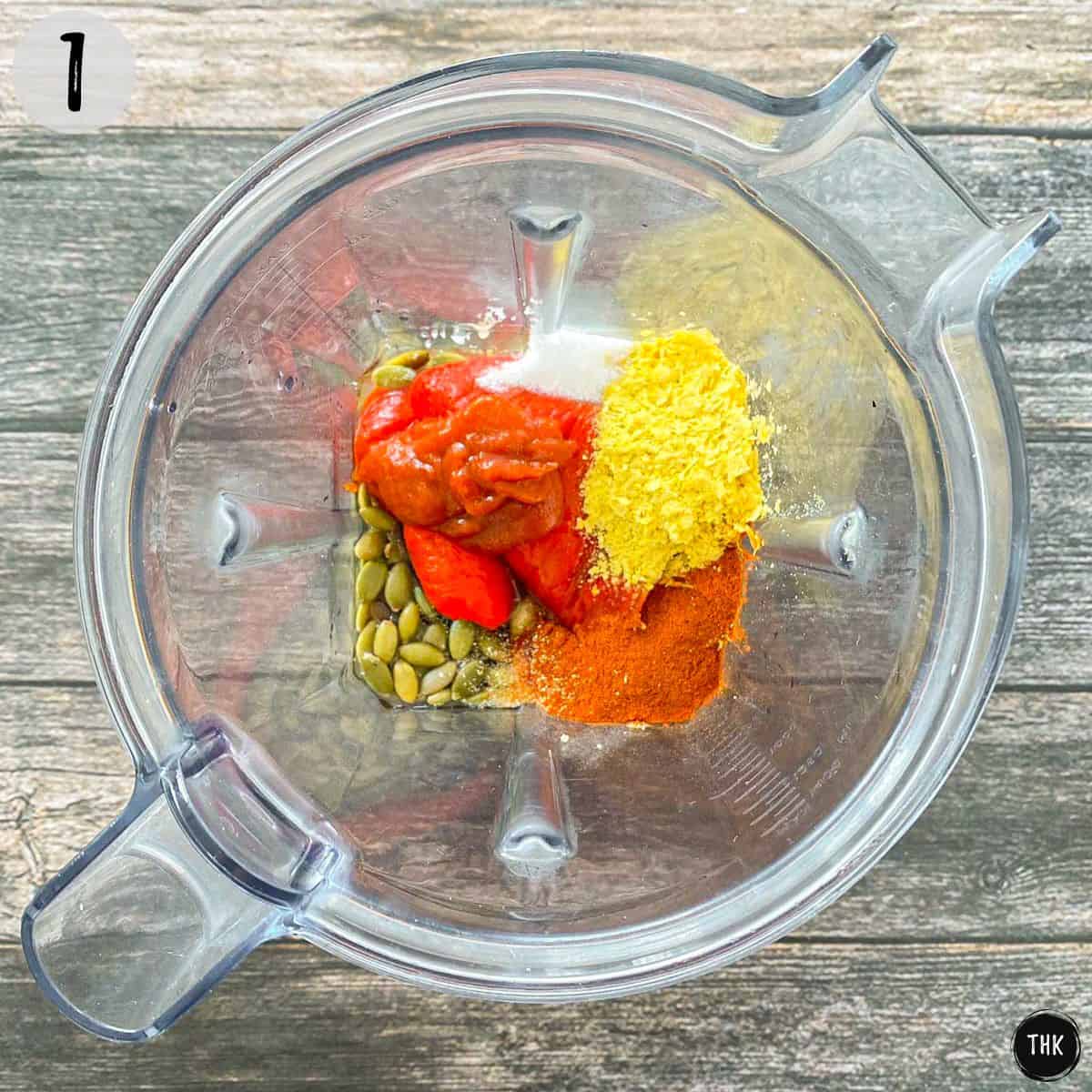 Pumpkin seeds, roasted red peppers, hot sauce and seasoning inside blender.