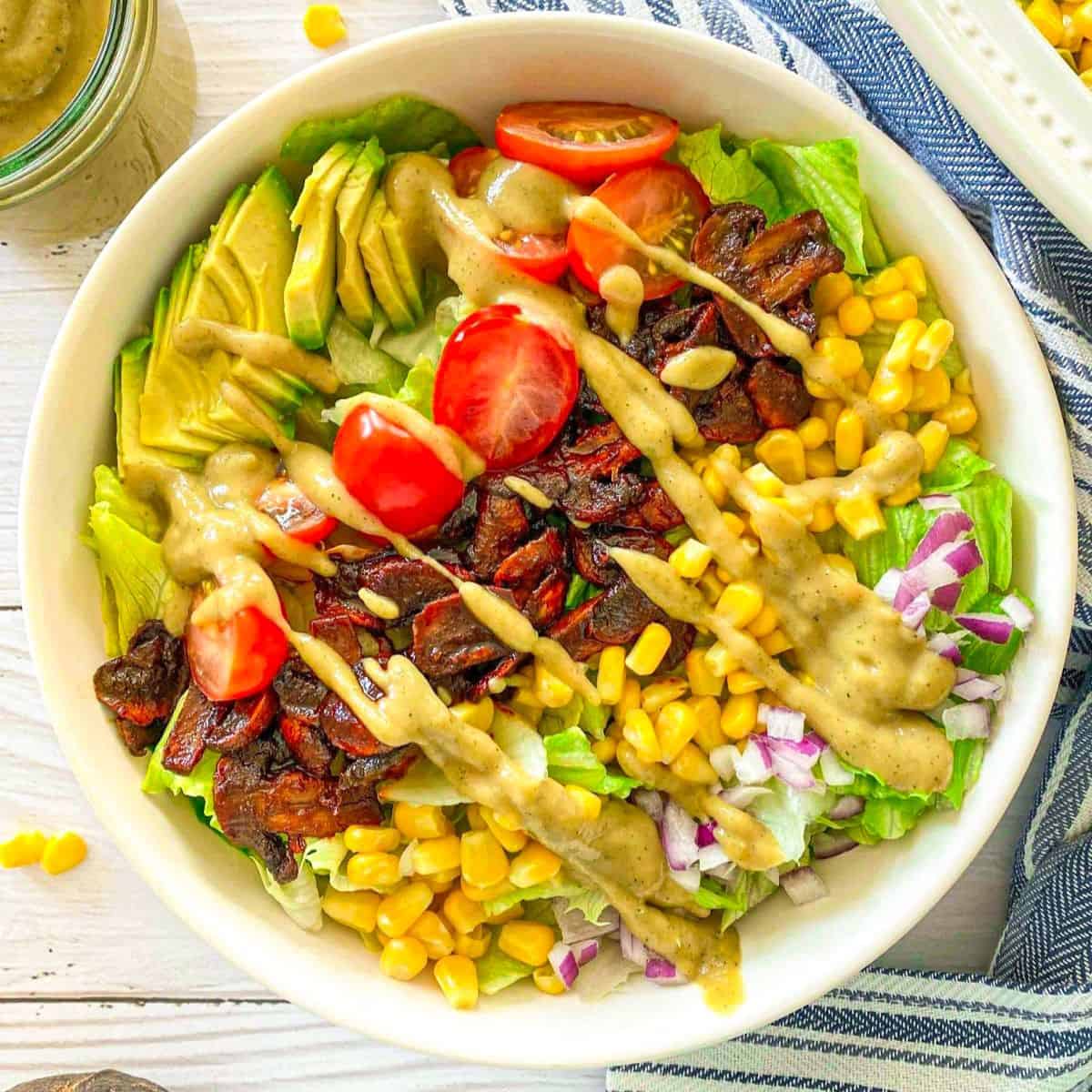 Vegan cobb salad with cheesy dressing on top.
