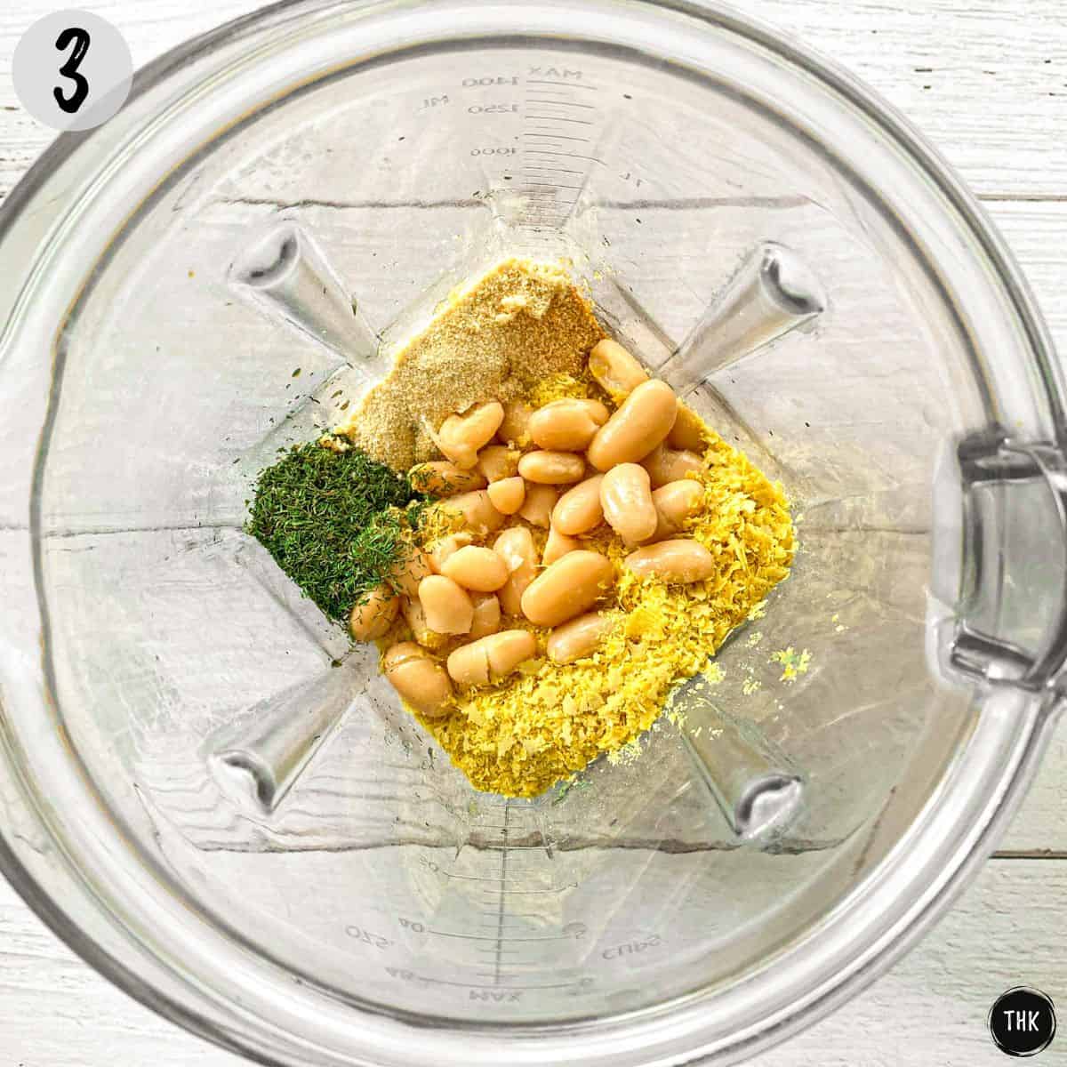 White beans, seasoning and vinegar inside blender.