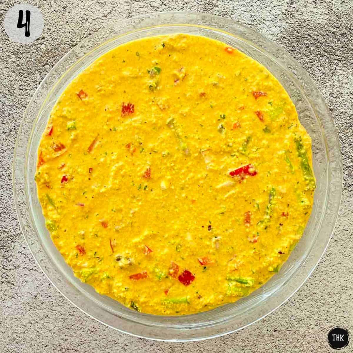 Pie plate with uncooked vegan frittata inside.