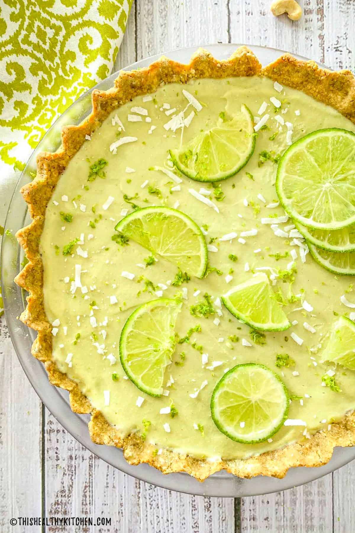 Vegan key lime pie with lime slices on top.