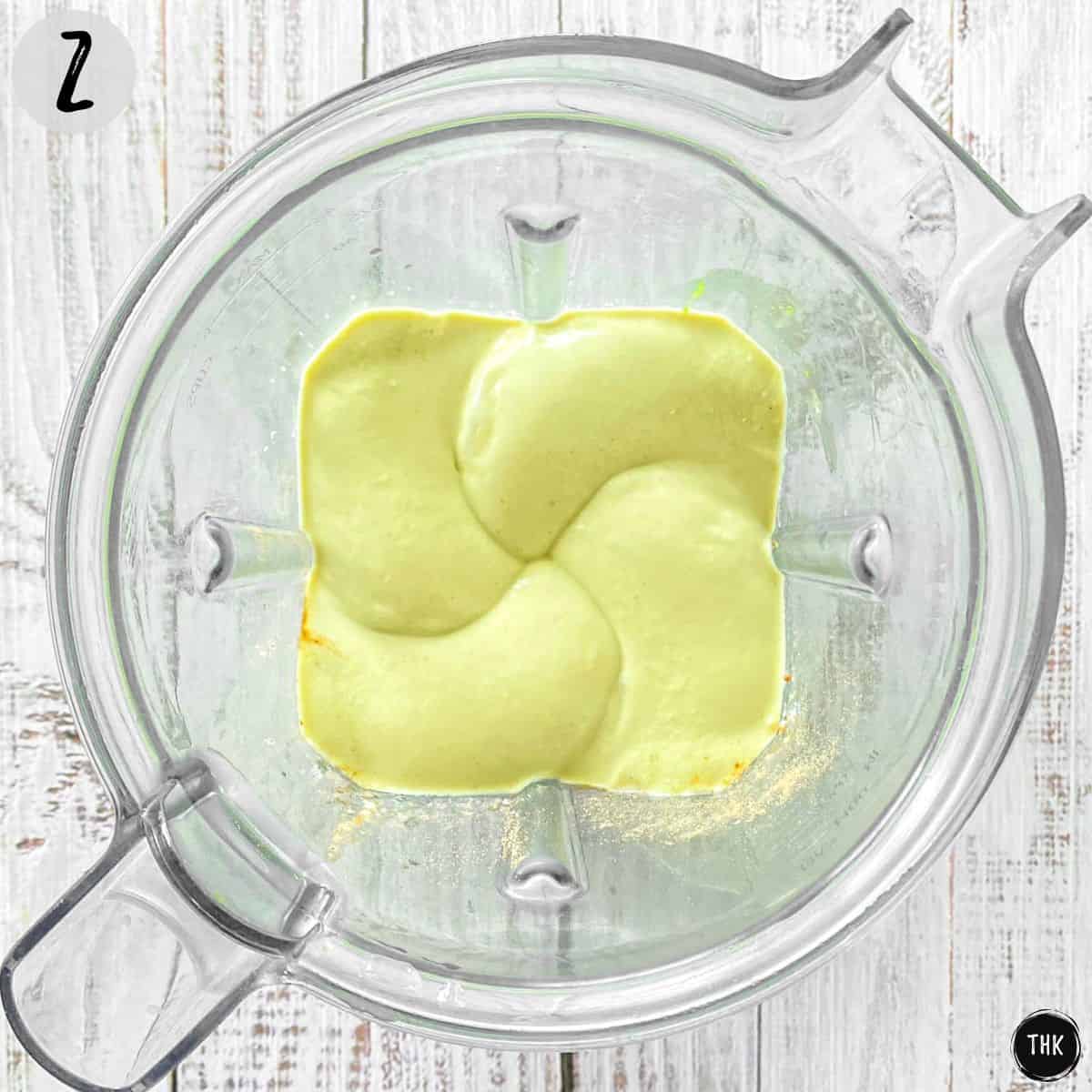 Smooth creamy green mixture inside blender.