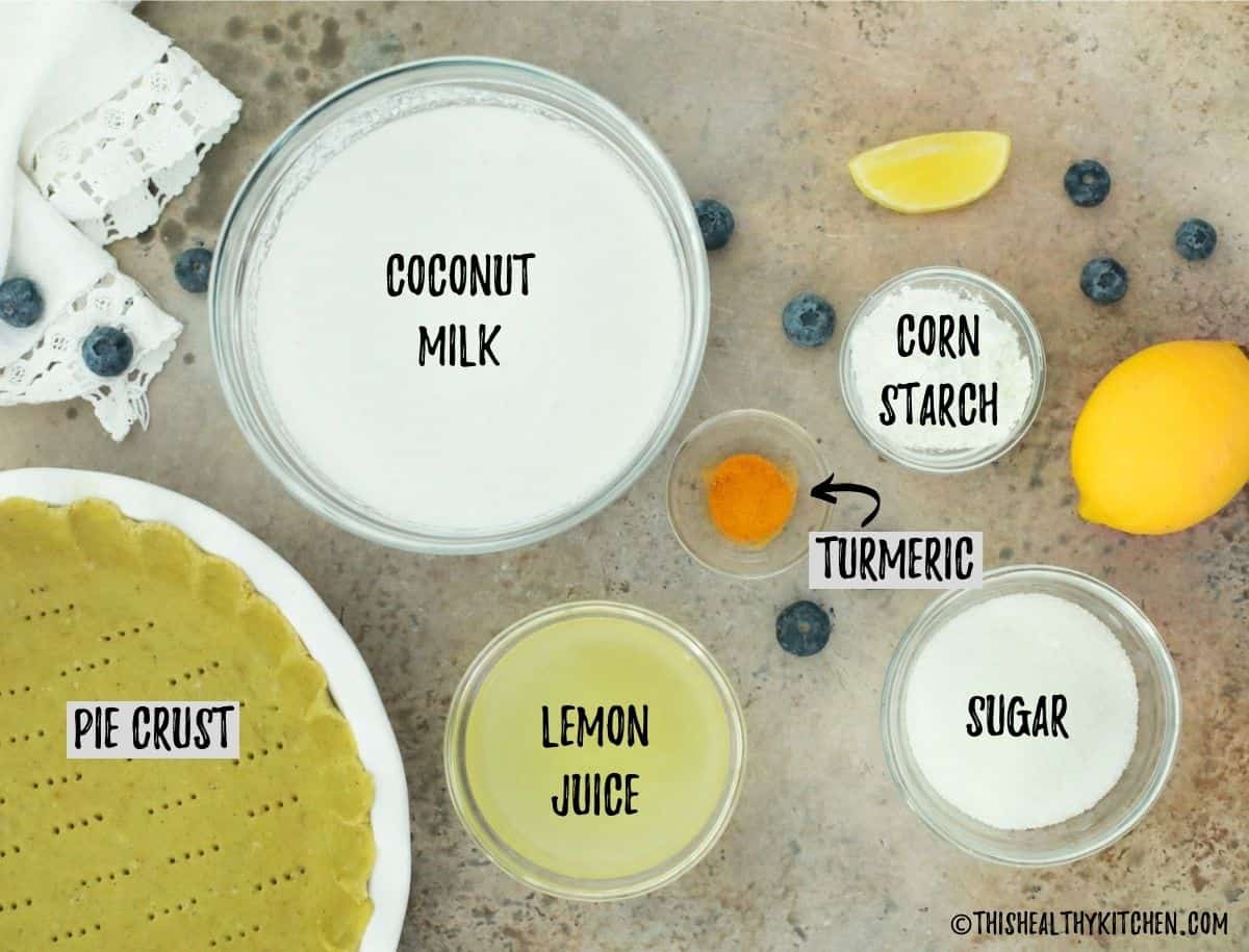 Pie crust in pie plate and lemon juice, seasoning and coconut milk in prep bowls.