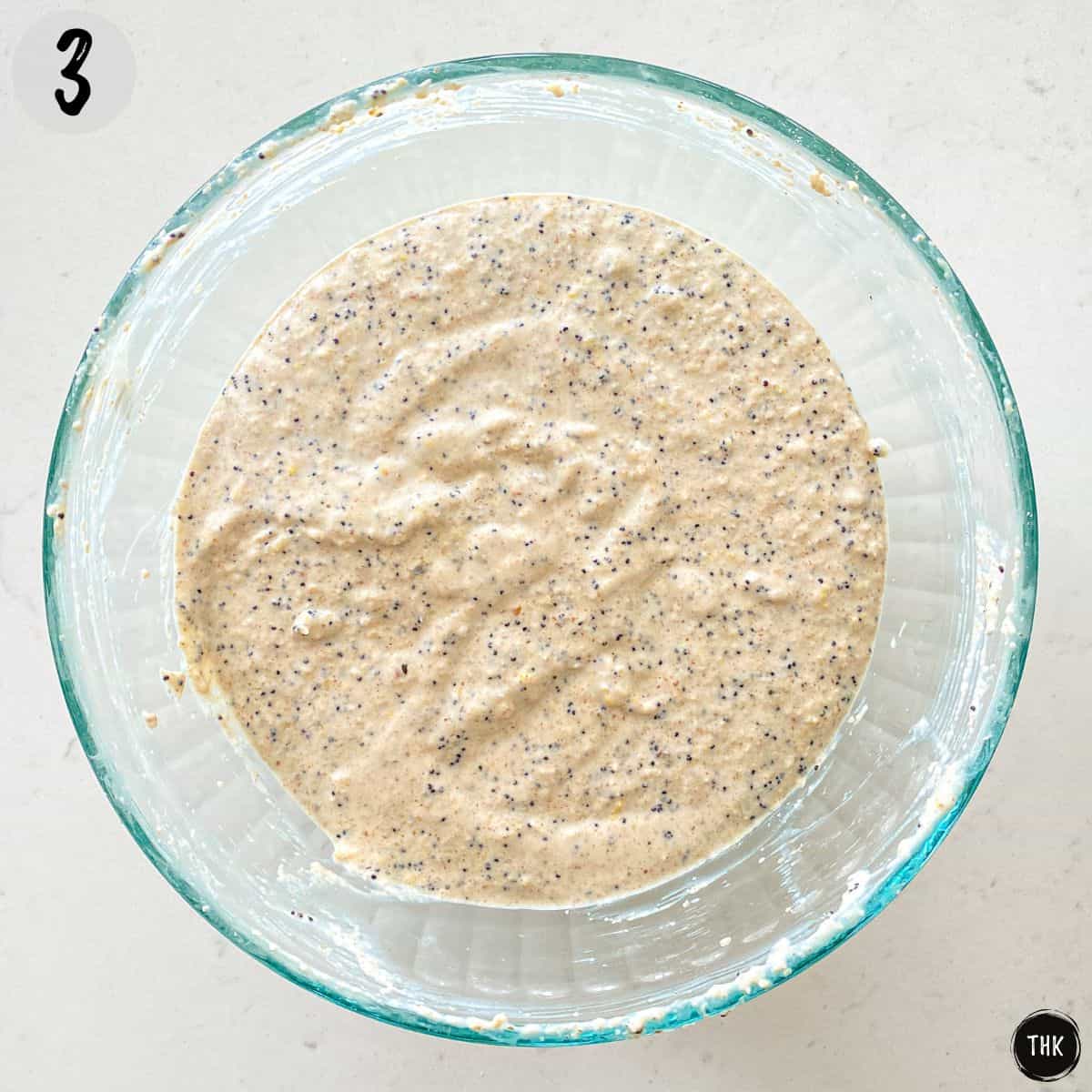 Pancake batter inside large glass bowl.