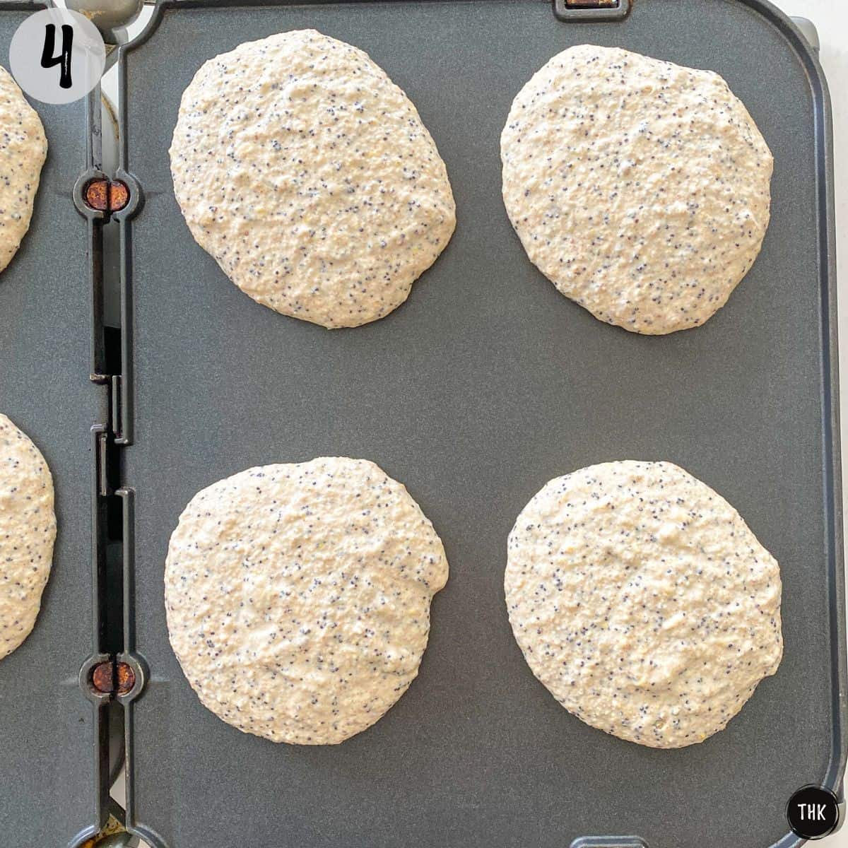 pancakes cooking on griddle.