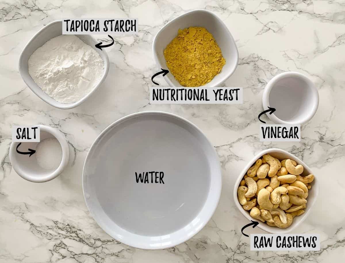 Ingredients to make vegan mozzarella cheese on marble counter.