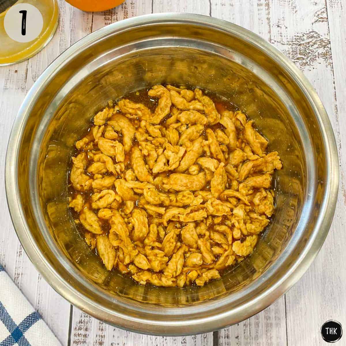Soy curls soaking with marinade in mixing bowl.