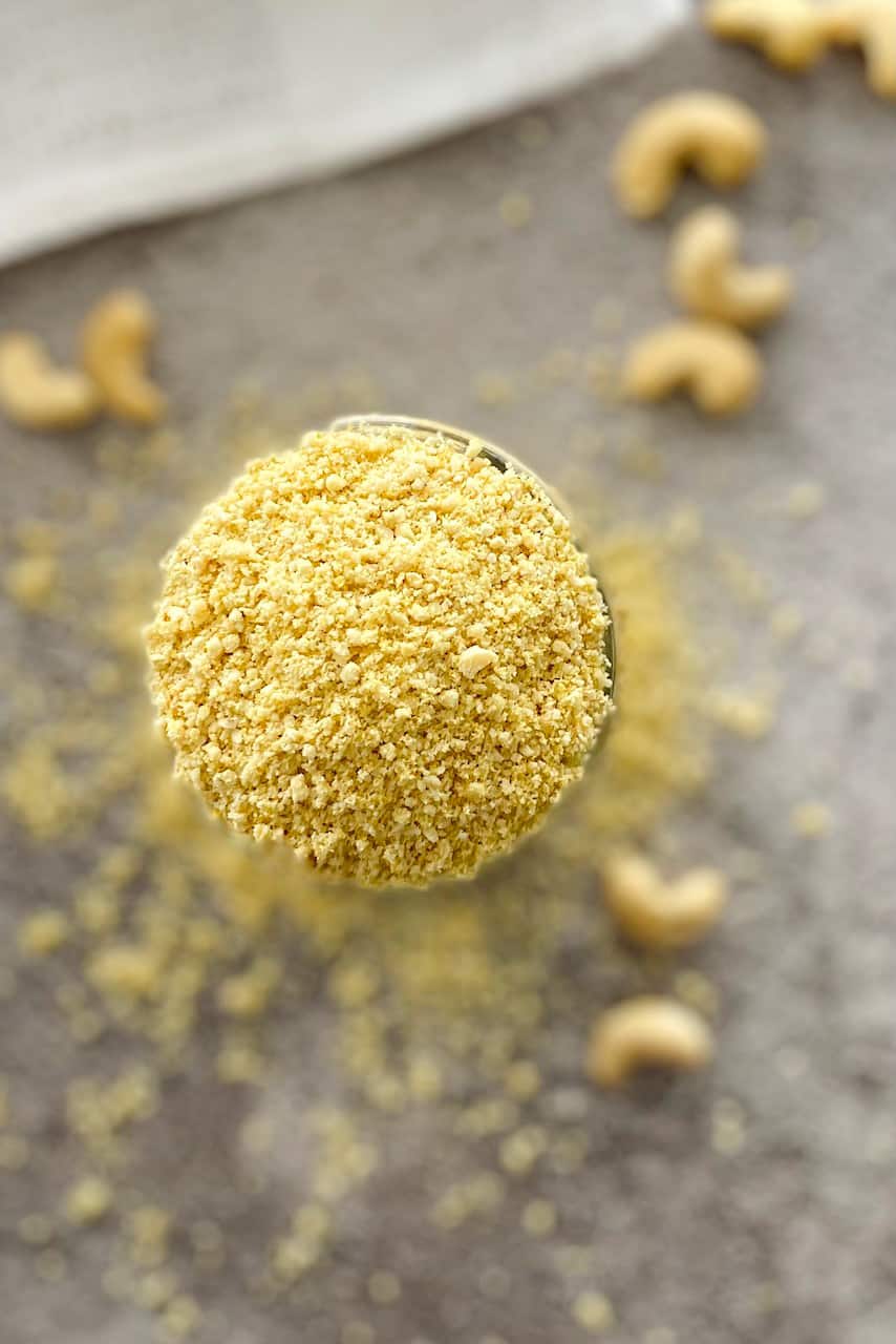 Glass jar overhead view filled with yellow powder seasoning.