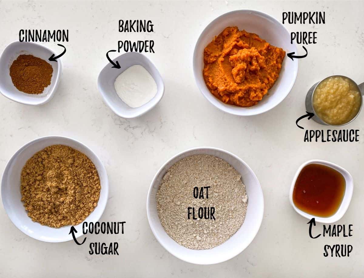 Ingredients to make pumpkin donuts scattered on kitchen counter.