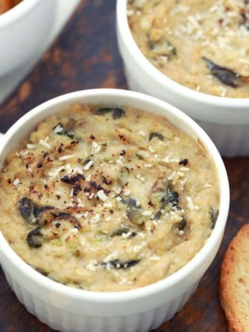 Vegan spinach dip in white corningware serving dish.