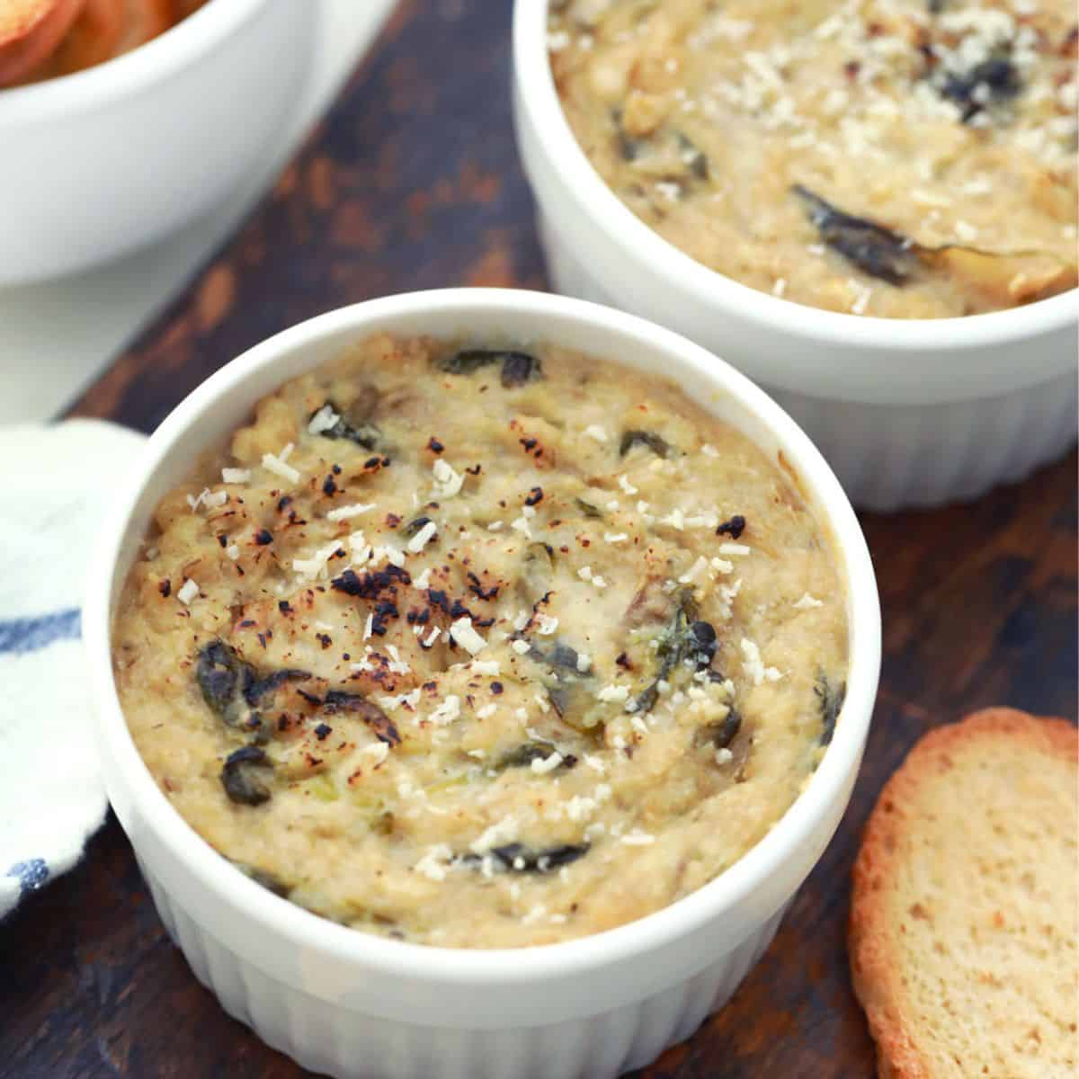 Vegan spinach dip in white corningware serving dish.