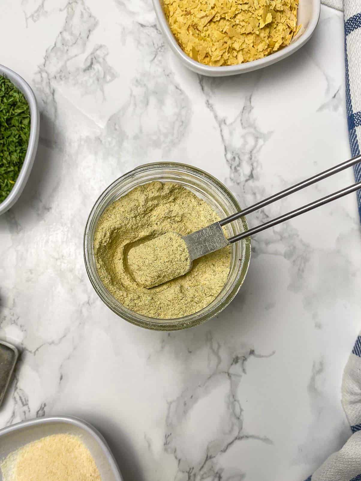 spoon inside jar of vegetable bouillon powder