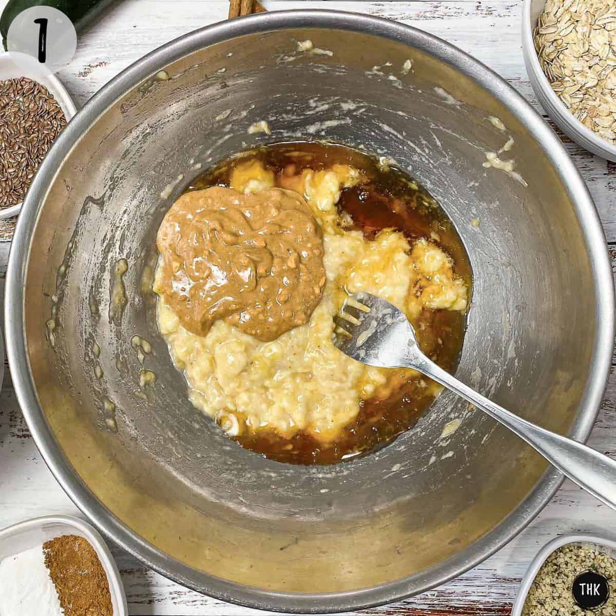 Large bowl with mashed banana, peanut butter, and maple syrup inside.