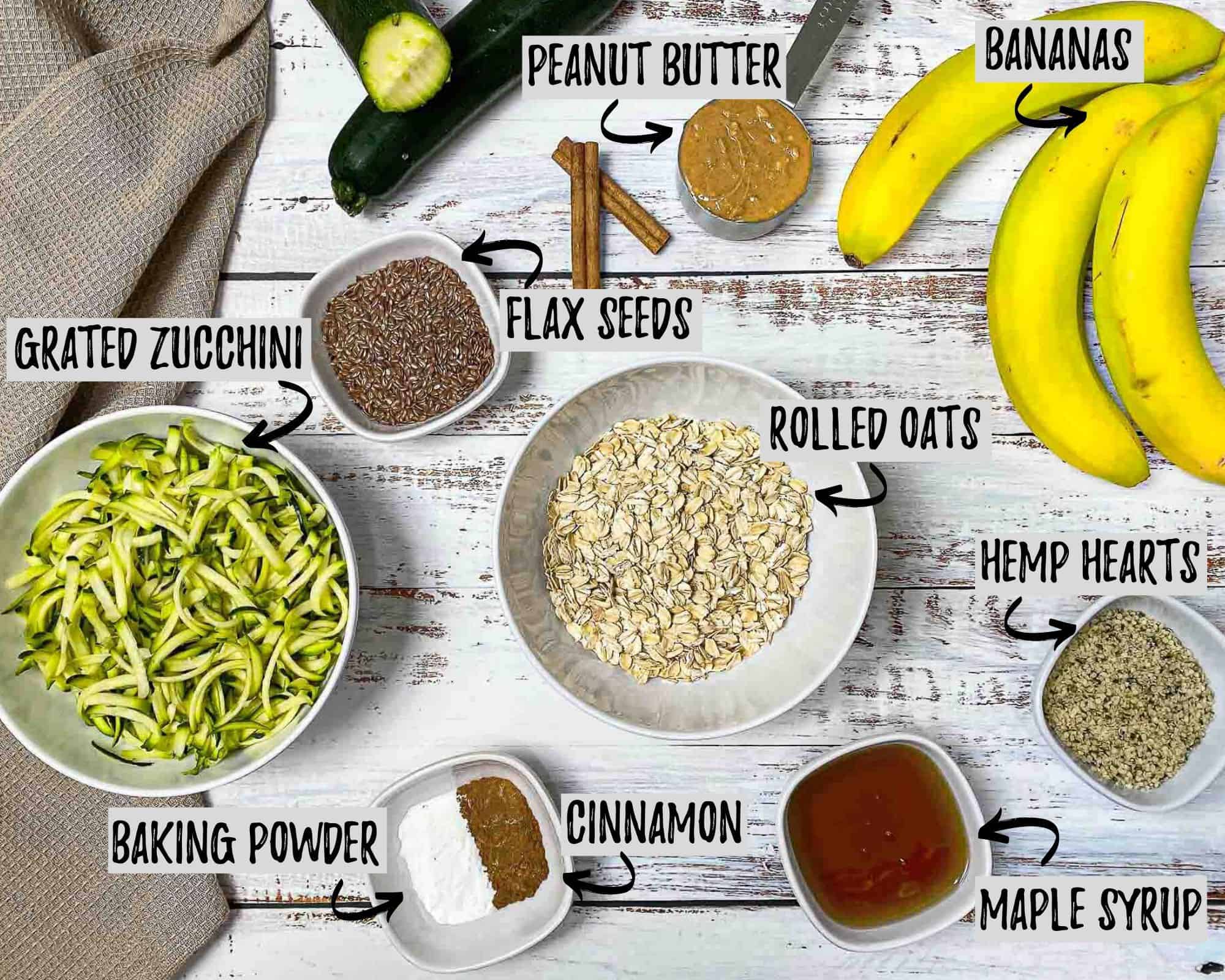 bowl of oats, grated zucchini, maple syrup, cinnamon, baking powder, peanut butter, flax seeds, and bananas